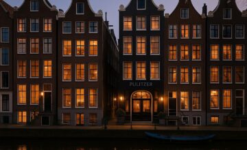 Pulitzer Amsterdam historic canal houses illuminated at dusk
