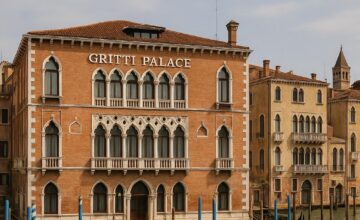 The Gritti Palace on Venice's Grand Canal with gondolas and historic architecture