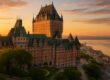 Fairmont Le Château Frontenac castle overlooking St. Lawrence River at sunrise